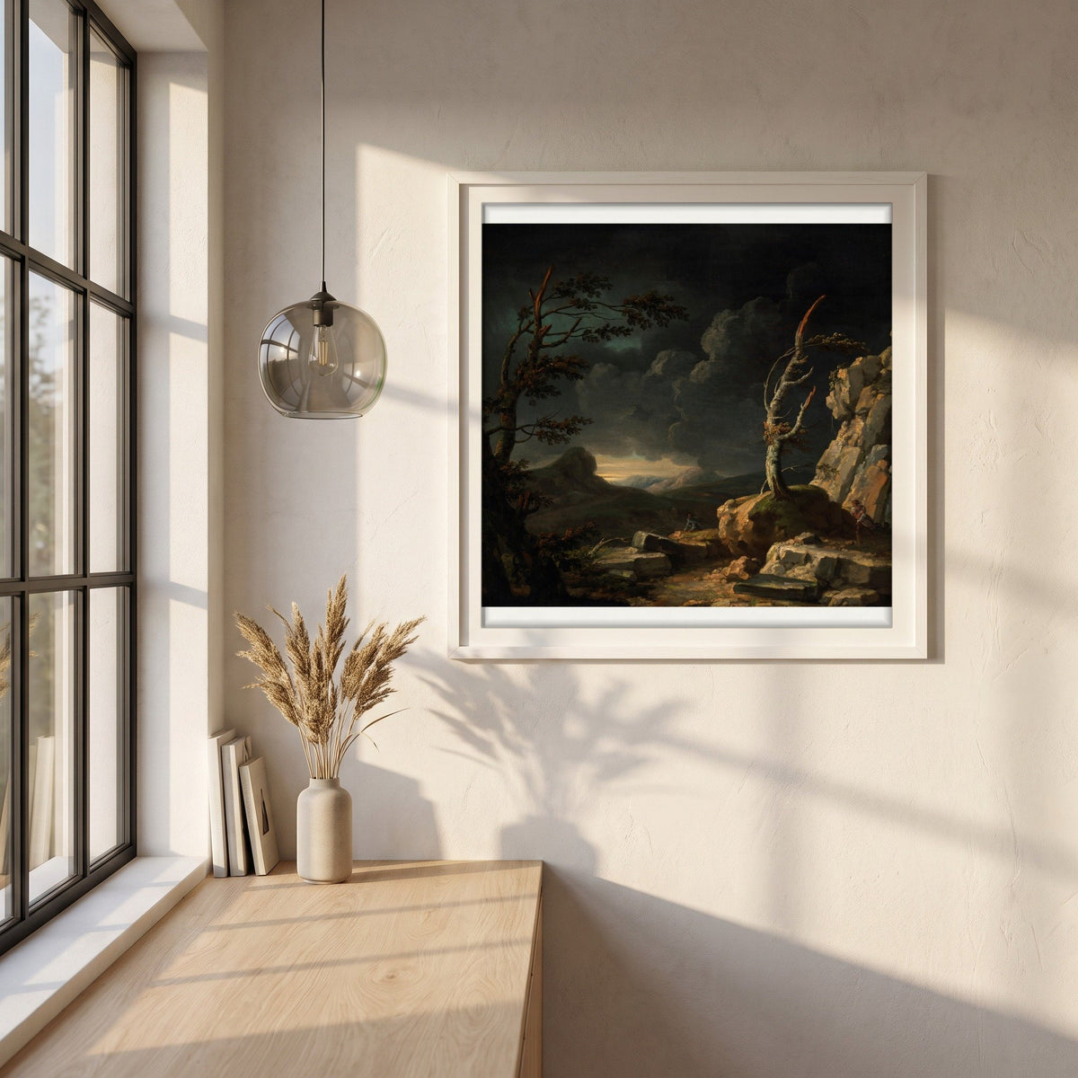A Stormy Landscape framed print in a white frame on a plaster wall above an oak worktop in a bright Scandinavian kitchen
