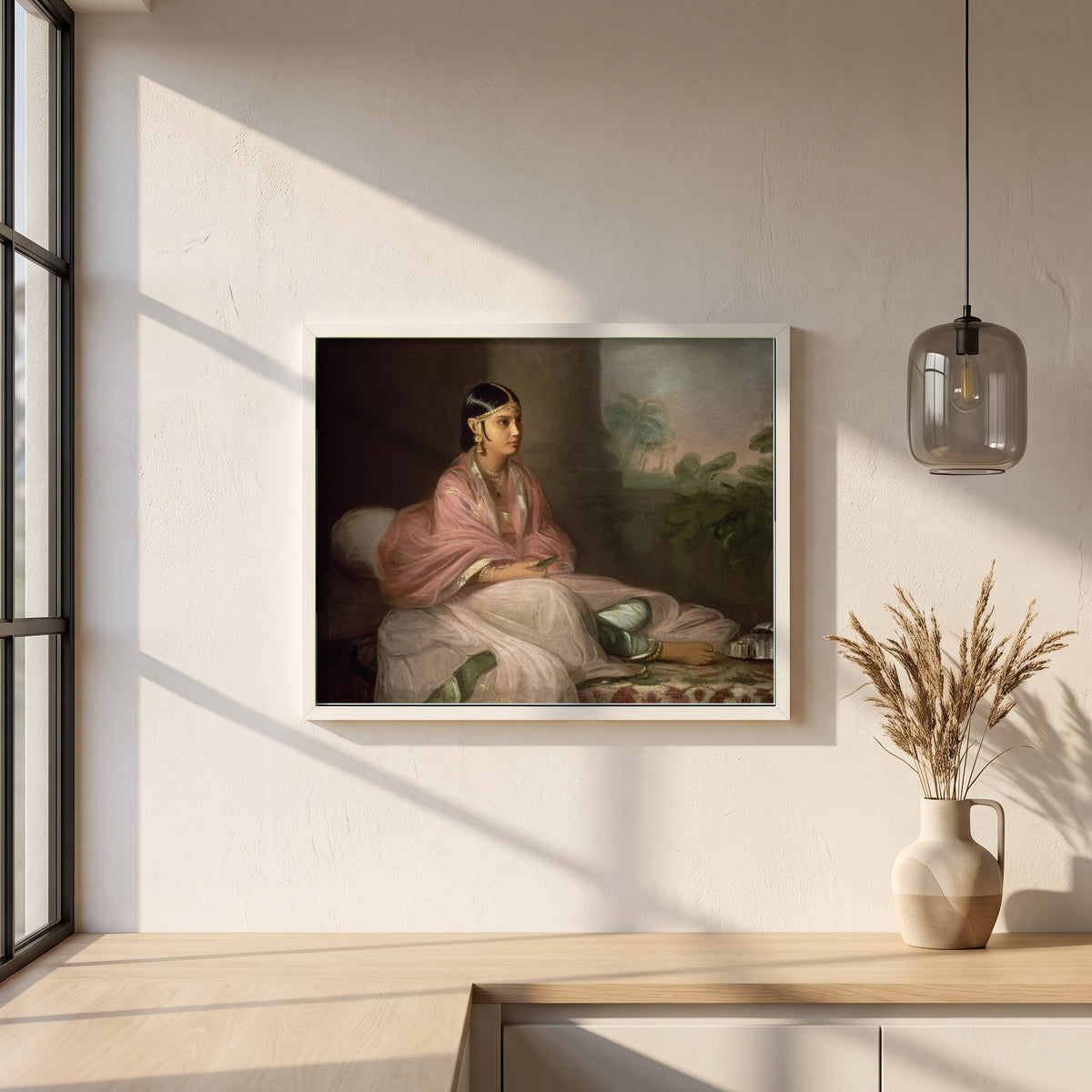 An Indian Lady framed print in a white frame on a plaster wall above an oak worktop in a bright Scandinavian kitchen