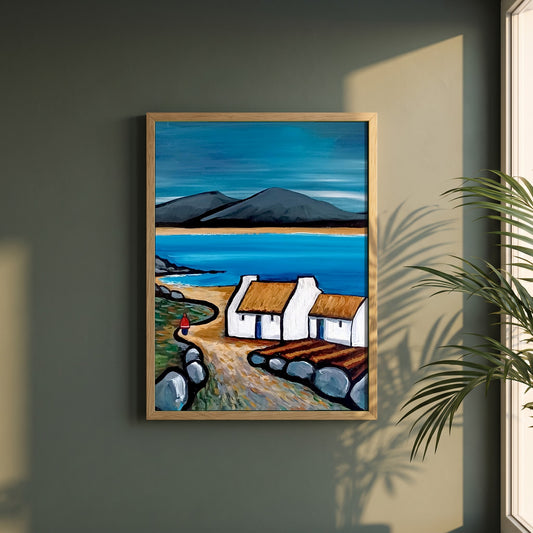 Connemara Lakes Cottage framed print in a natural oak frame on a dark green wall beside a window, dappled plant shadow