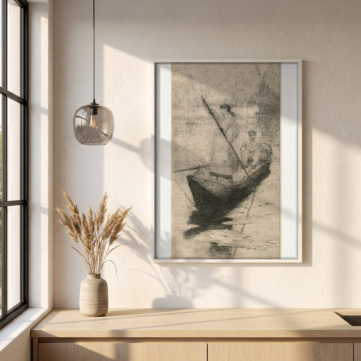 Figures in a Boat framed print in a white frame on a plaster wall above an oak worktop in a bright Scandinavian kitchen