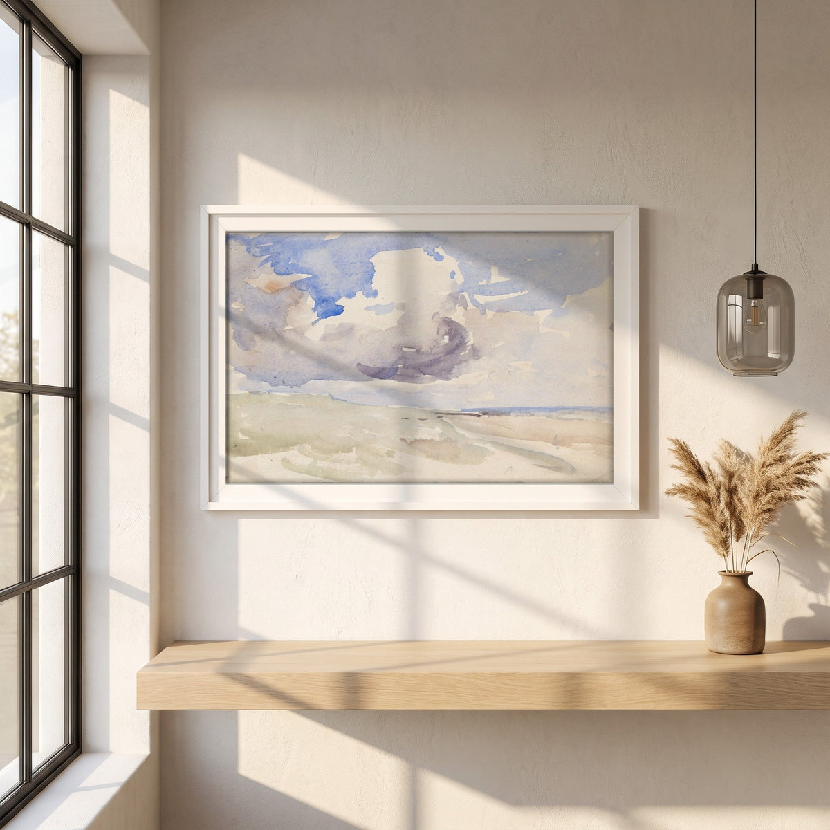 Low Clouds over a Beach framed print in a white frame on a plaster wall above an oak worktop in a bright Scandinavian kitchen