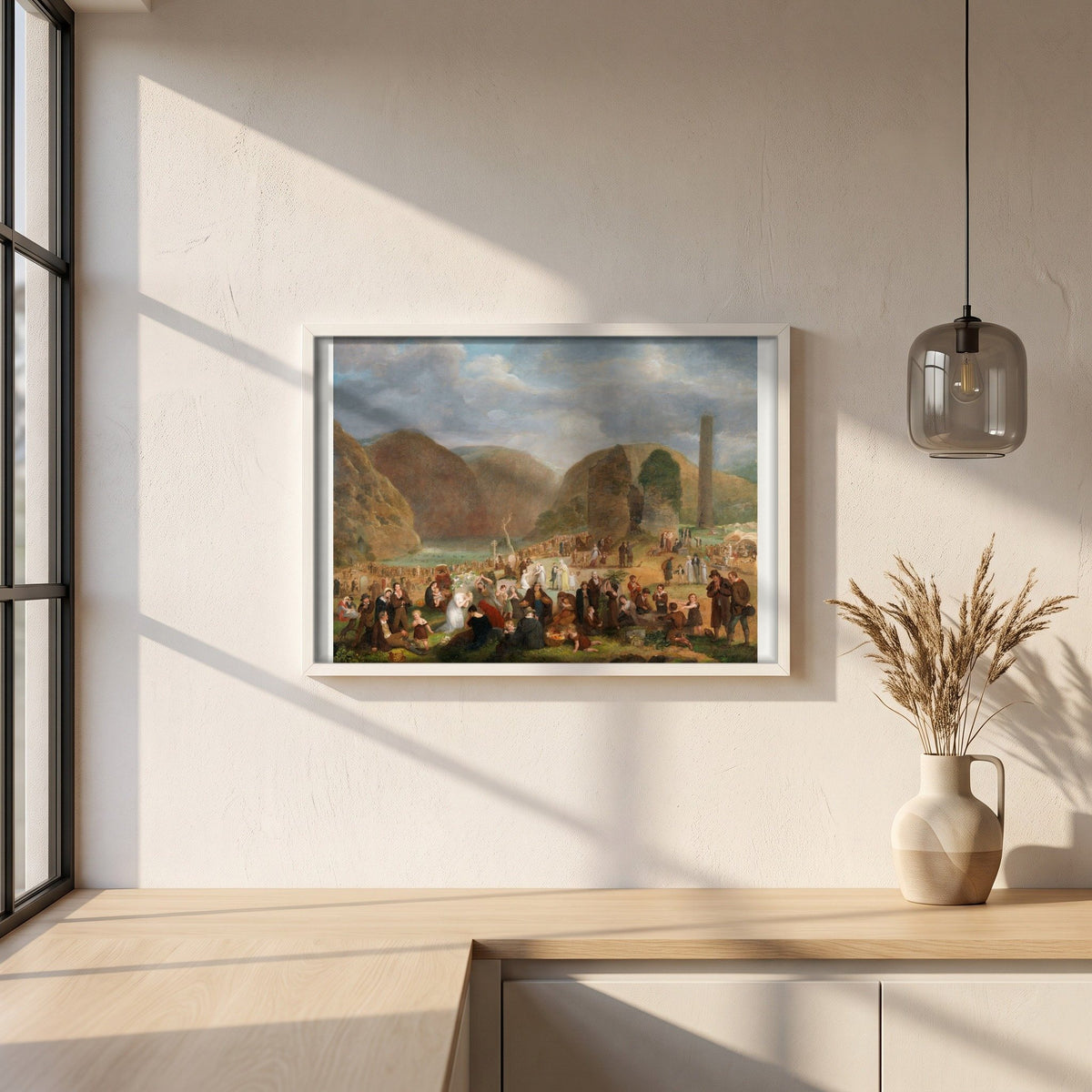 Patron's Day at the Seven Churches, Glendalough (c.1816) framed print in a white frame on a plaster wall above an oak worktop in a bright Scandinavian kitchen