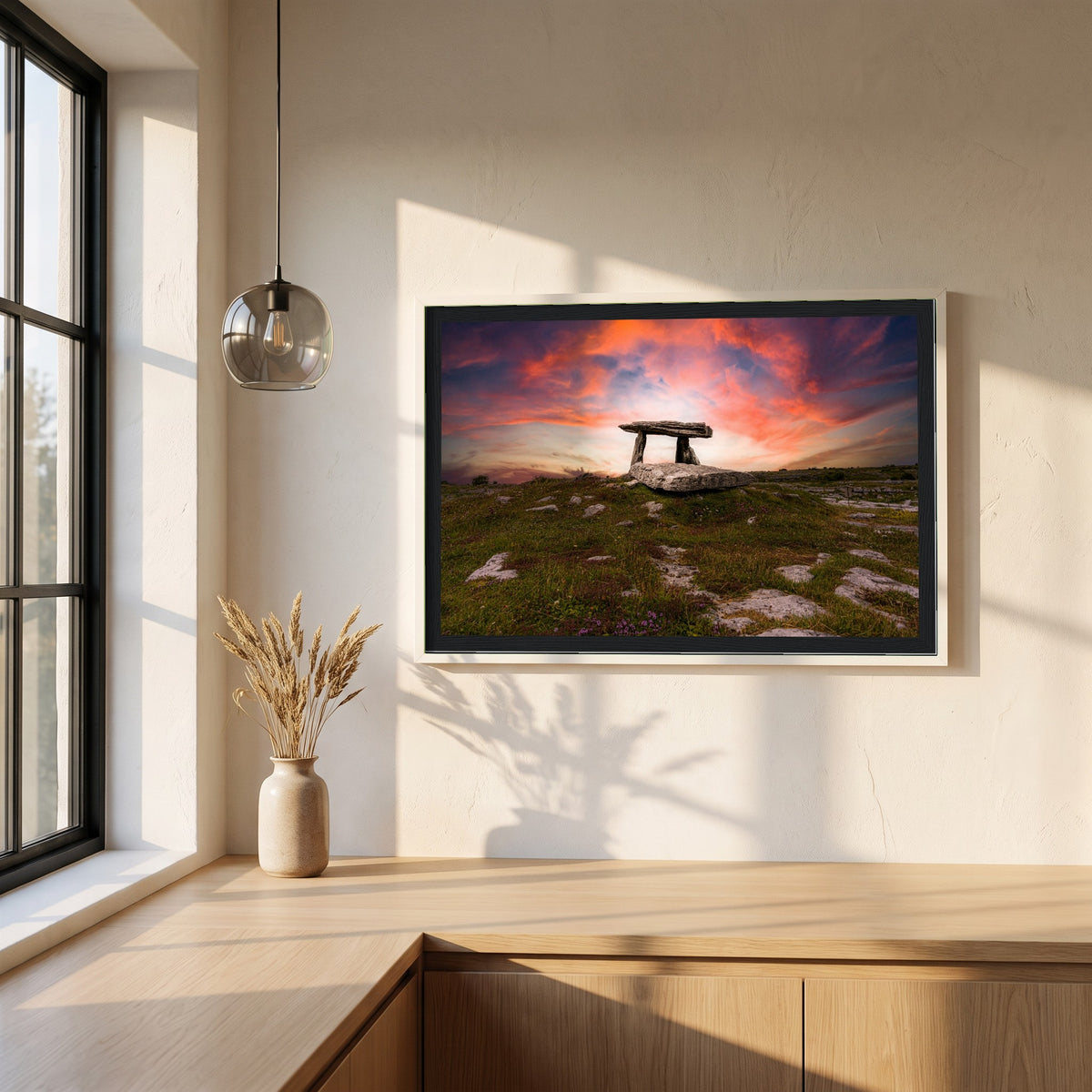 Poulnabrone Dolmen framed print in a white frame on a plaster wall above an oak worktop in a bright Scandinavian kitchen