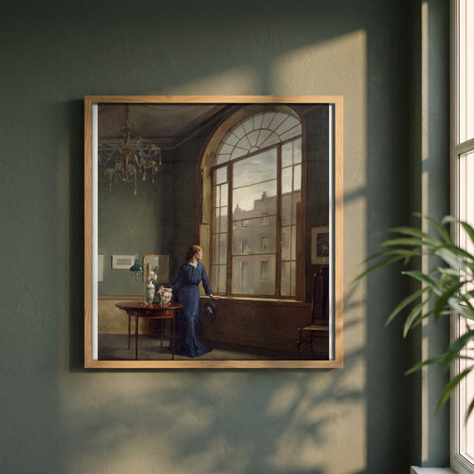 Window in London Street framed print in a natural oak frame on a dark green wall beside a window, dappled plant shadow