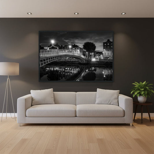 Black and white night photograph of the Ha'penny Bridge in Dublin reflected in the River Liffey, framed