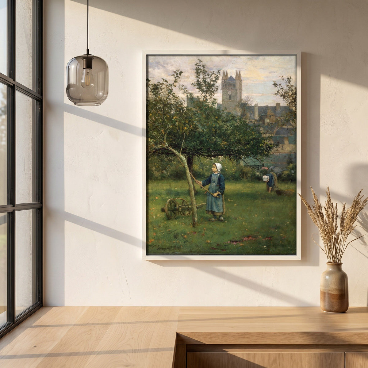 Apple Gathering, Quimperlé framed print in a white frame on a plaster wall above an oak worktop in a bright Scandinavian kitchen