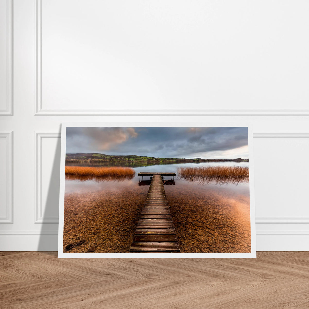 Old Jetty, Lough Derg print in a white frame with a white mount on a herringbone wooden floor