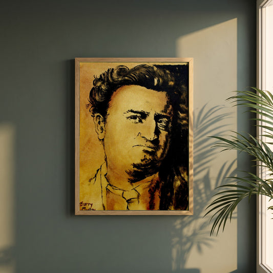 Brendan Behan framed print in a natural oak frame on a dark green wall beside a window, dappled plant shadow