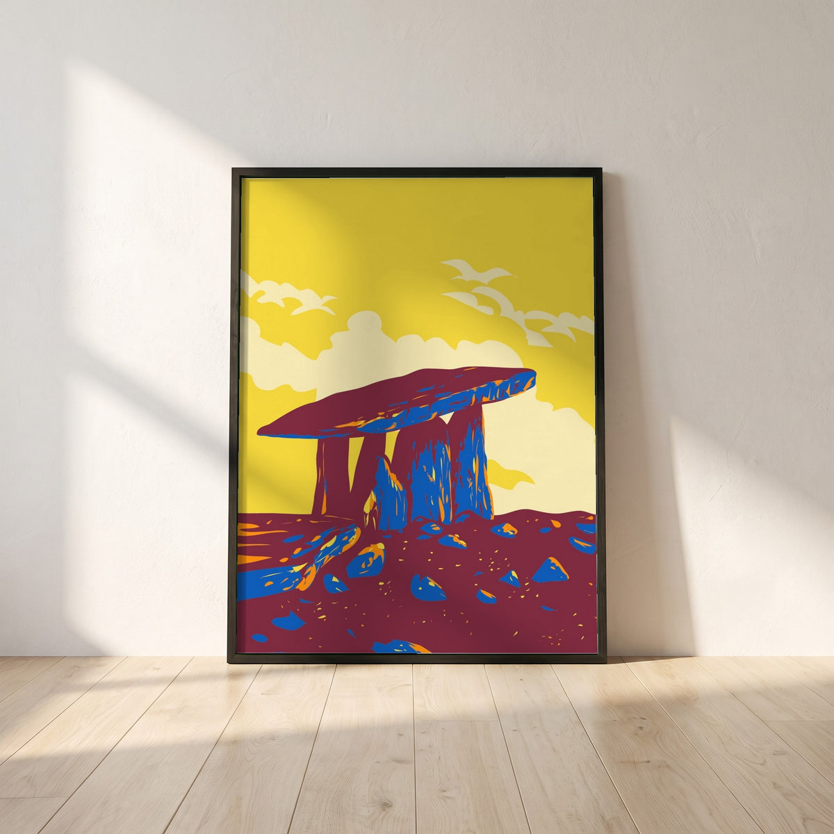 The Burren Poulnabrone Dolmen framed print in a black frame leaning against a white plaster wall on oak floorboards in morning light