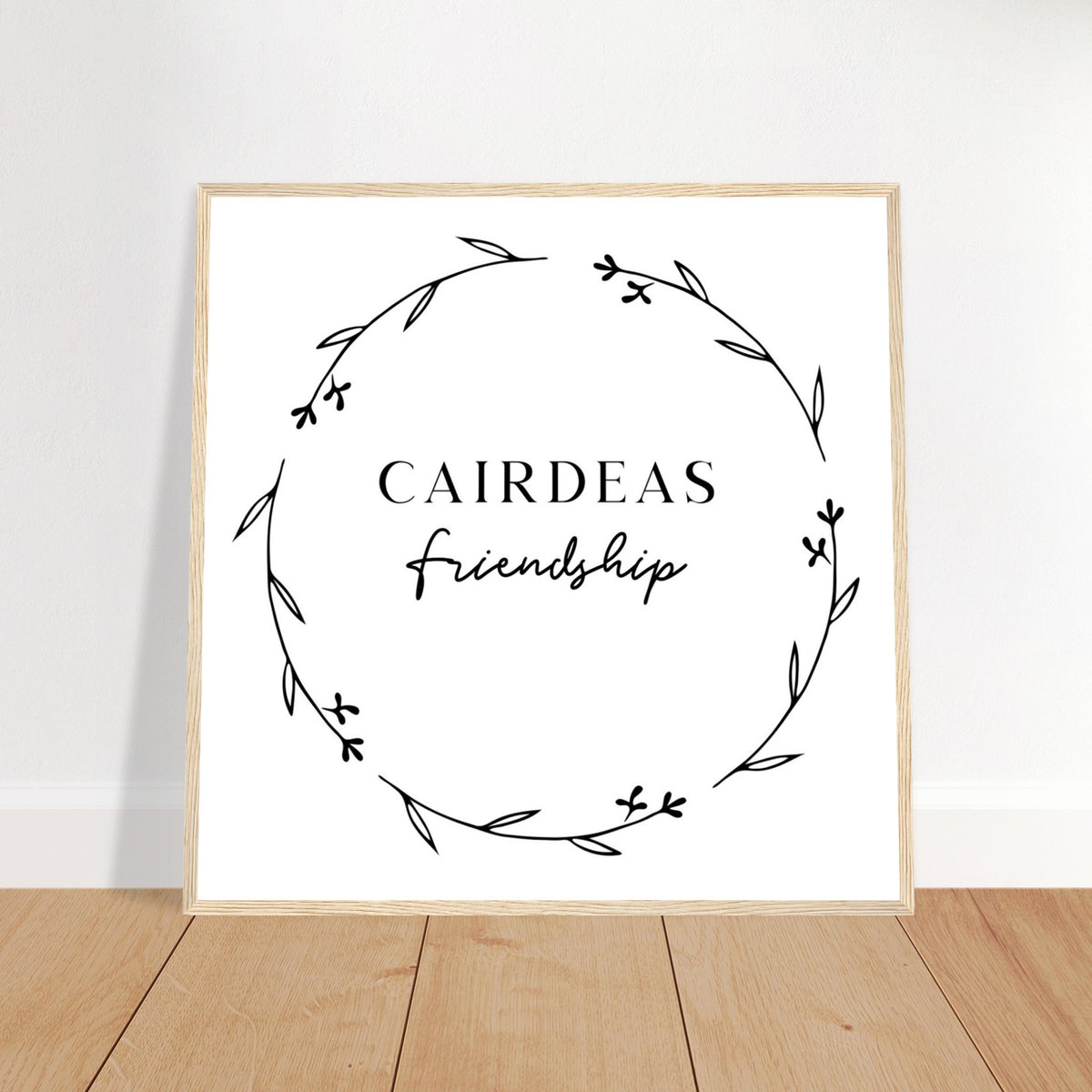 Cairdeas Friendship Irish language print in an oak frame leaning on a wooden floor