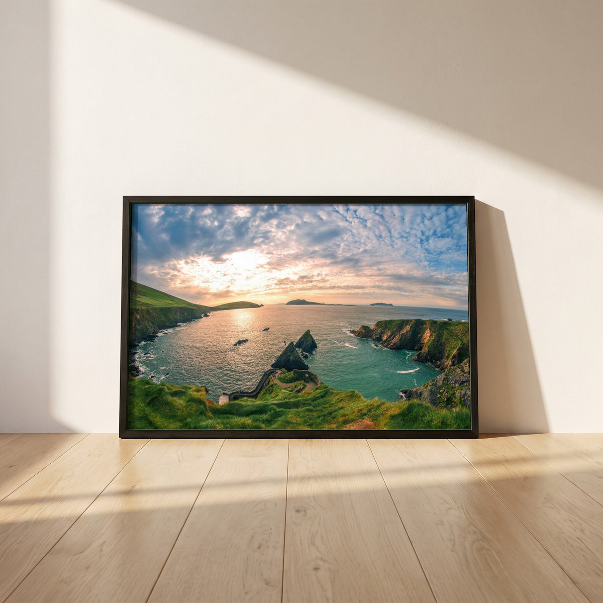 Dingle Peninsula framed print in a black frame leaning against a white plaster wall on oak floorboards in morning light