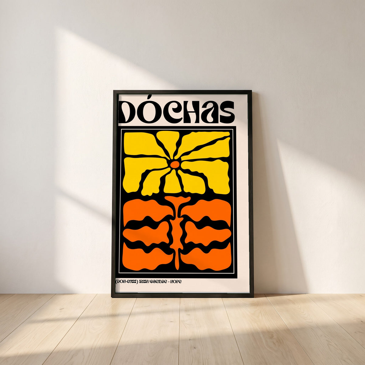 Dóchas framed print in a black frame leaning against a white plaster wall on oak floorboards in morning light