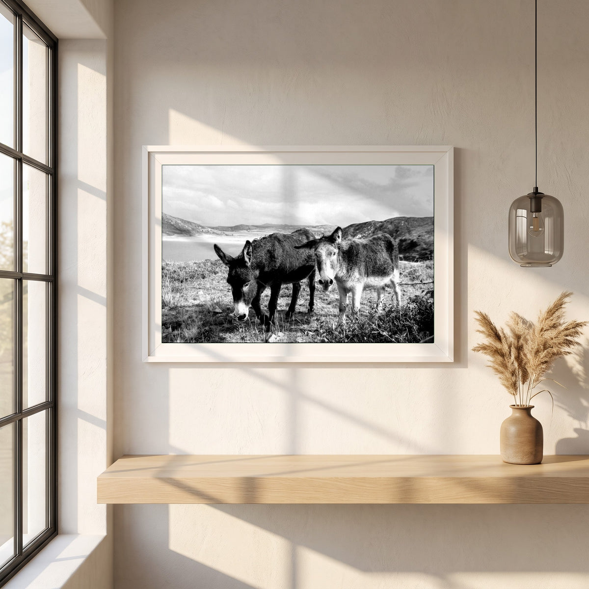 Donegal framed print in a white frame on a plaster wall above an oak worktop in a bright Scandinavian kitchen