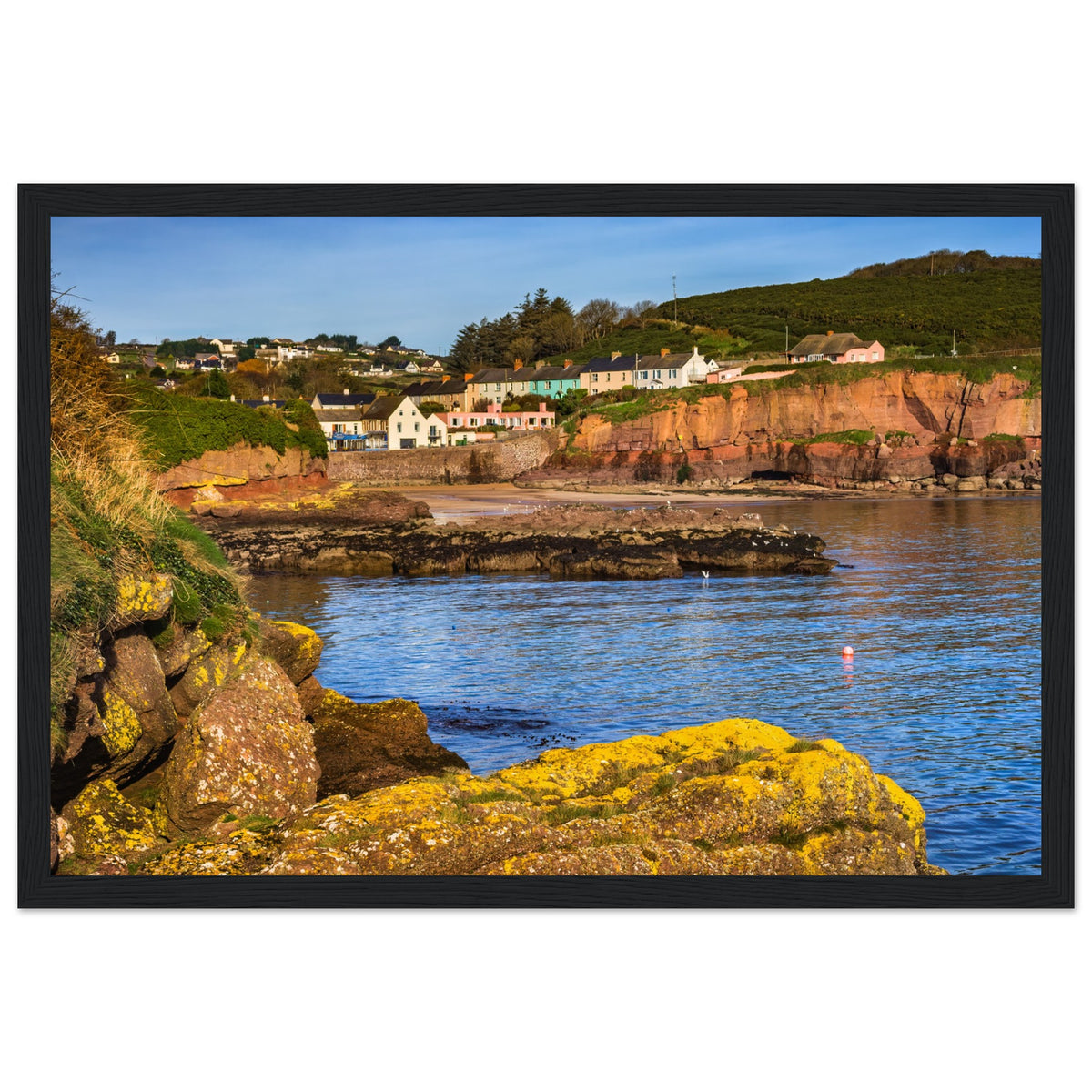Dunmore East bay and village under a clear sky, photographic print in a thick black frame