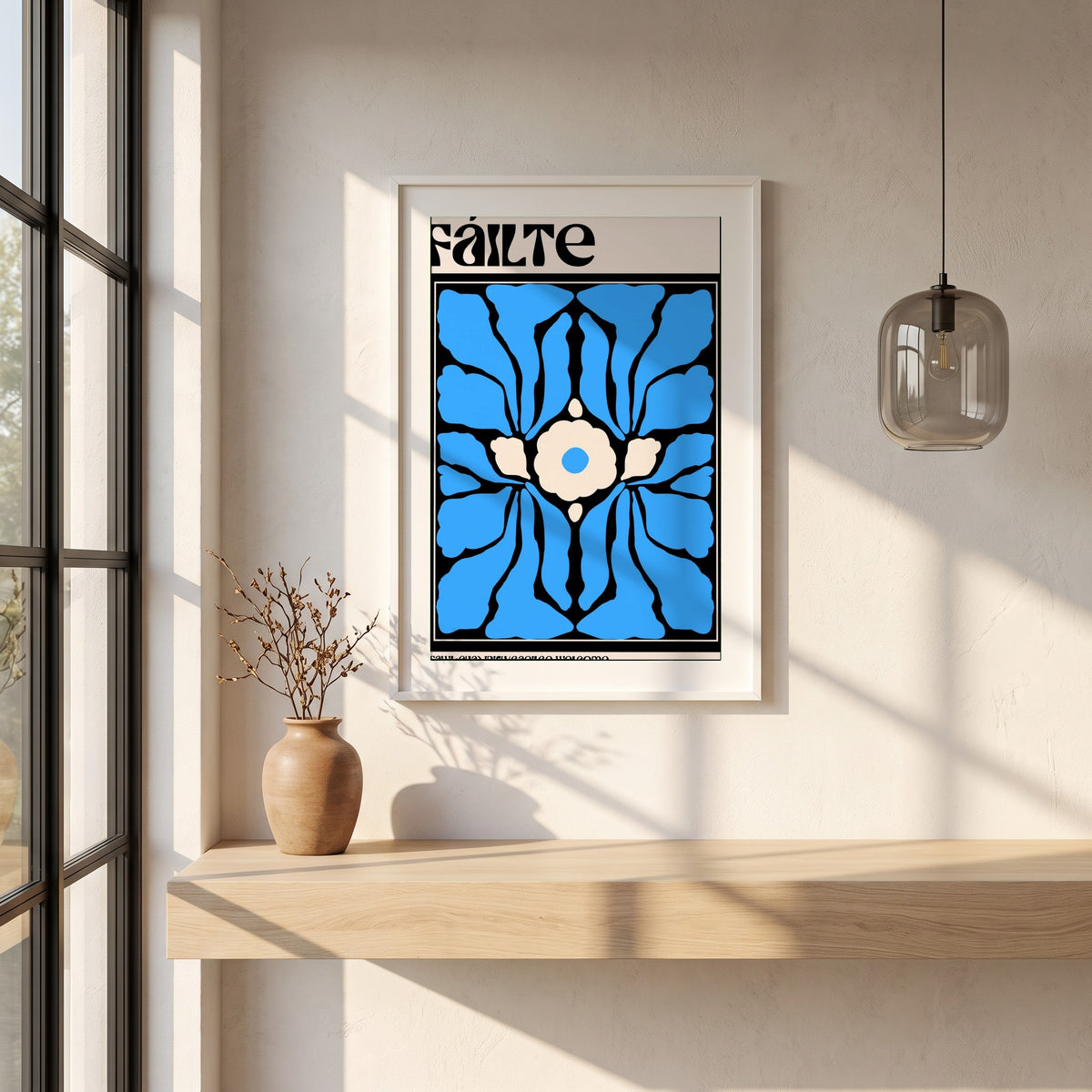Fáilte framed print in a white frame on a plaster wall above an oak worktop in a bright Scandinavian kitchen