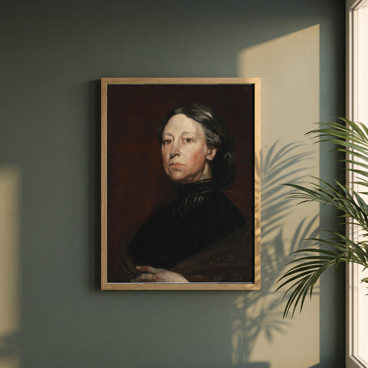 Augusta Lady Gregory framed print in a natural oak frame on a dark green wall beside a window, dappled plant shadow