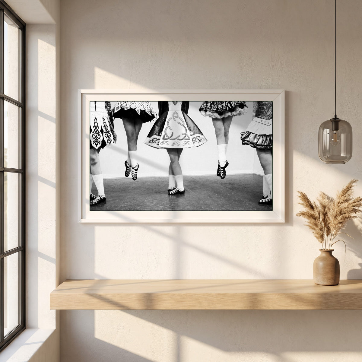 Irish Dancing Black & White framed print in a white frame on a plaster wall above an oak worktop in a bright Scandinavian kitchen