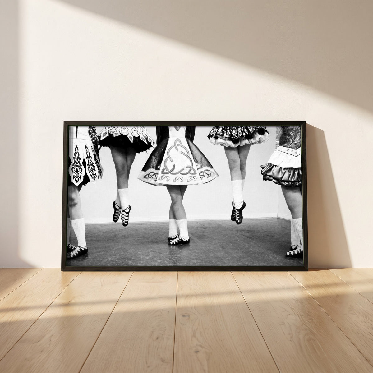 Irish Dancing Black & White framed print in a black frame leaning against a white plaster wall on oak floorboards in morning light