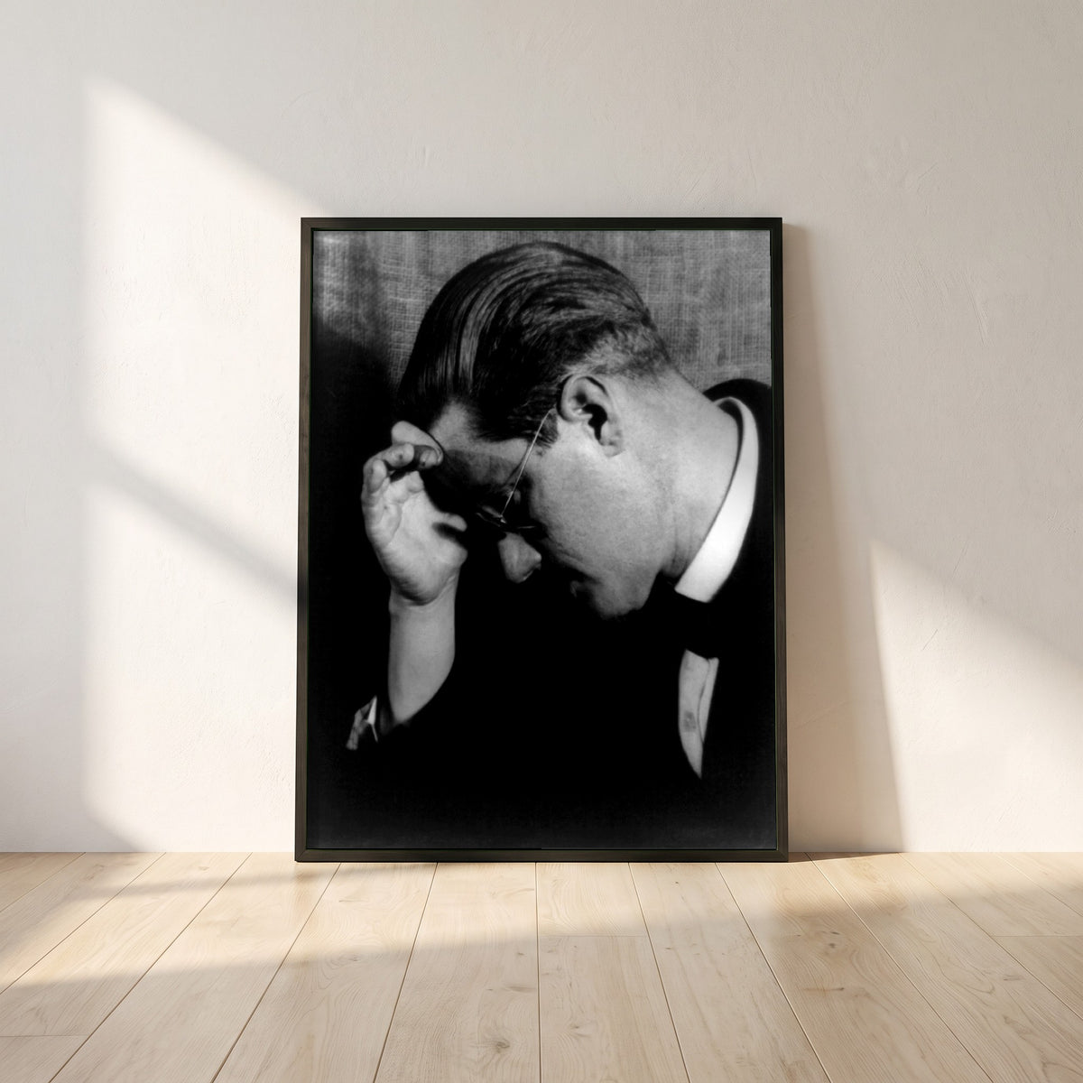 James Joyce Black & White framed print in a black frame leaning against a white plaster wall on oak floorboards in morning light