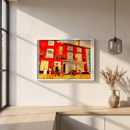 Johnny Joe's Pub, Cushendall framed print in a white frame on a plaster wall above an oak worktop in a bright Scandinavian kitchen