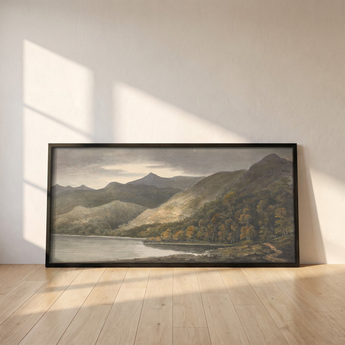 Killarney, Panoramic framed print in a black frame leaning against a white plaster wall on oak floorboards in morning light