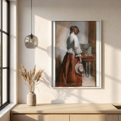 Lady with a Birdcage framed print in a white frame on a plaster wall above an oak worktop in a bright Scandinavian kitchen