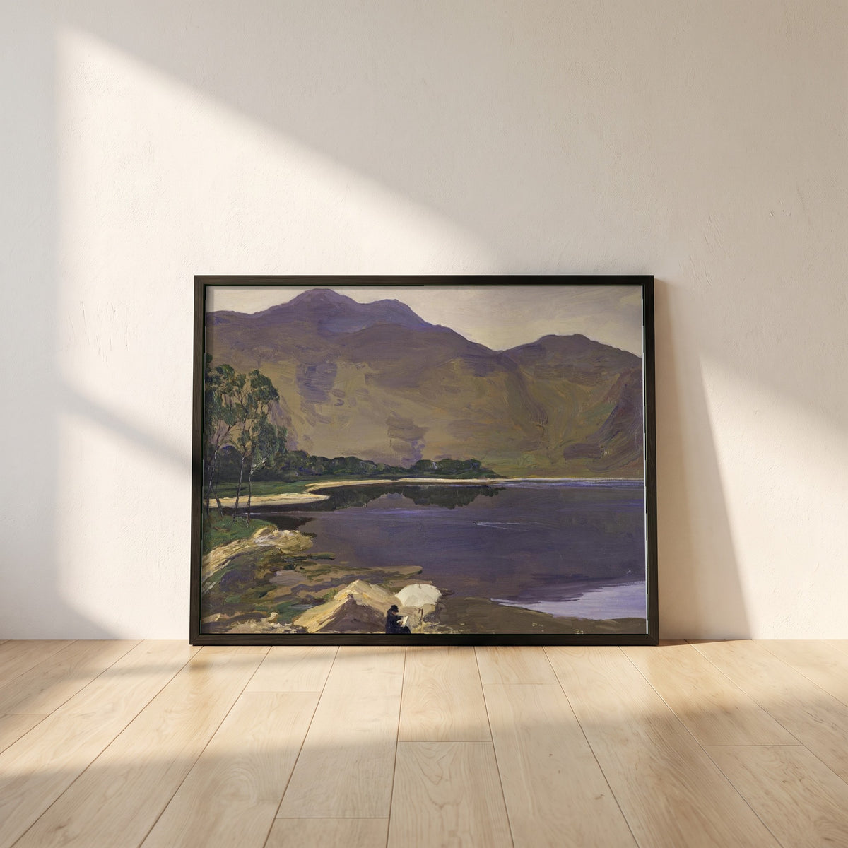 Loch Katrine framed print in a black frame leaning against a white plaster wall on oak floorboards in morning light