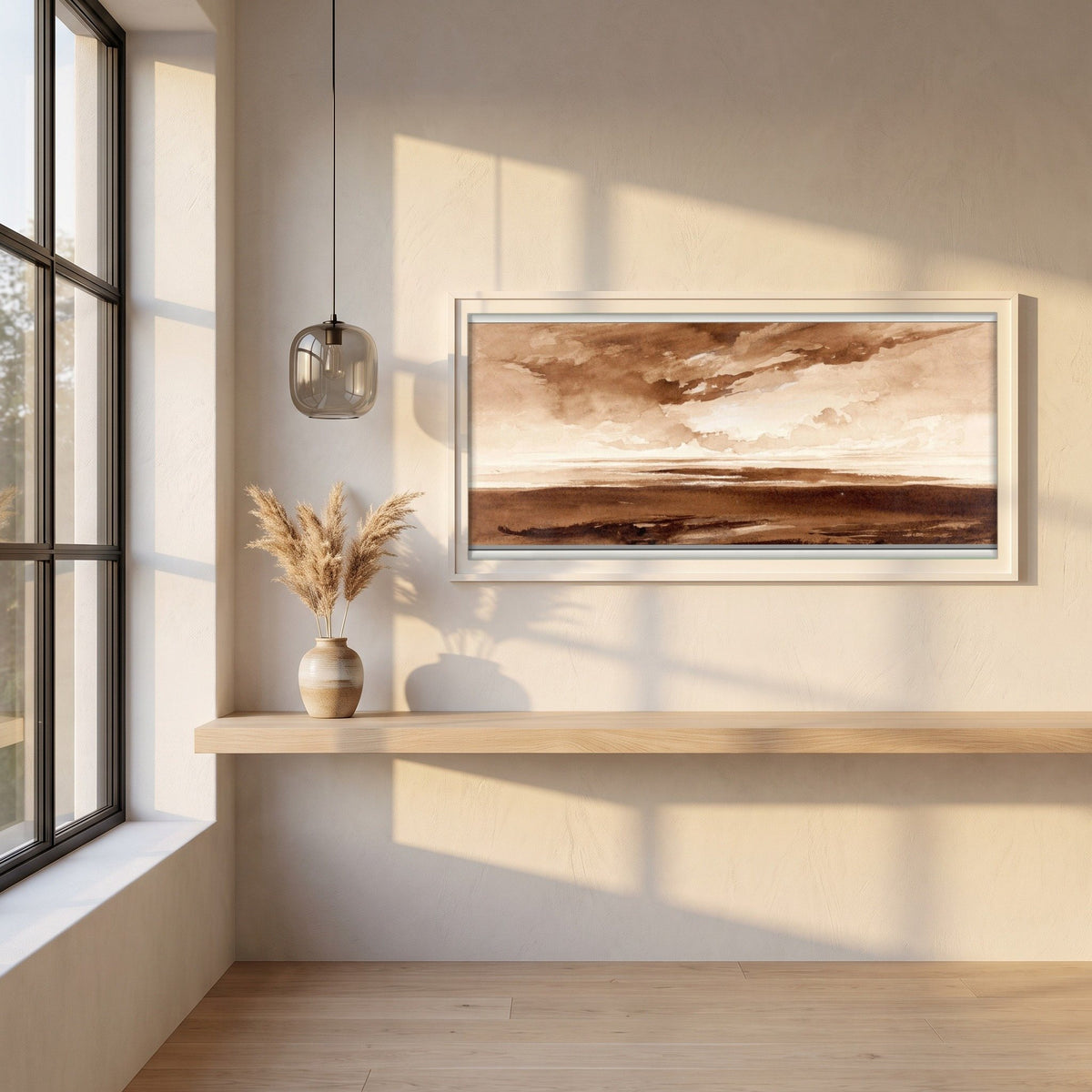 Panorama of the Coast at Sunset framed print in a white frame on a plaster wall above an oak worktop in a bright Scandinavian kitchen