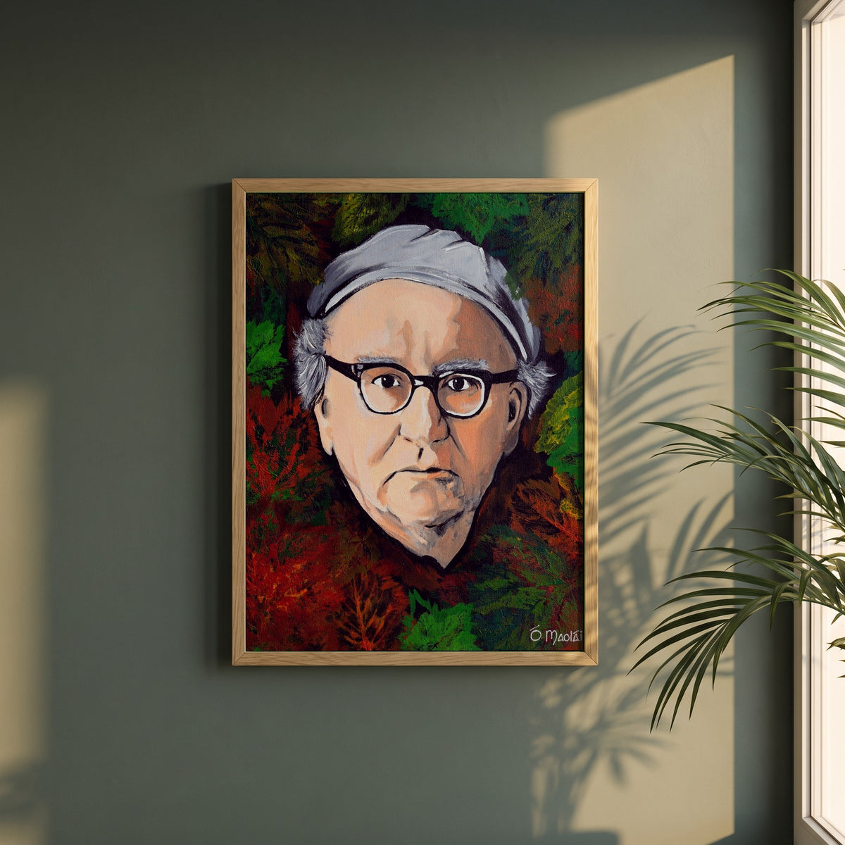 Patrick Kavanagh framed print in a natural oak frame on a dark green wall beside a window, dappled plant shadow