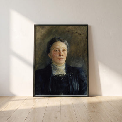 Portrait of Augusta Gregory framed print in a black frame leaning against a white plaster wall on oak floorboards in morning light