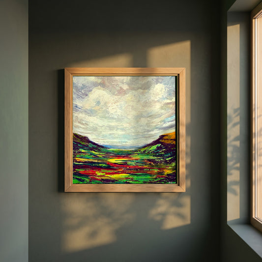 Glenariff framed print in a natural oak frame on a dark green wall beside a window, dappled plant shadow