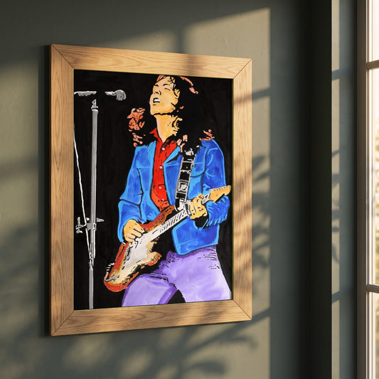 Rory Gallagher framed print in a natural oak frame on a dark green wall beside a window, dappled plant shadow