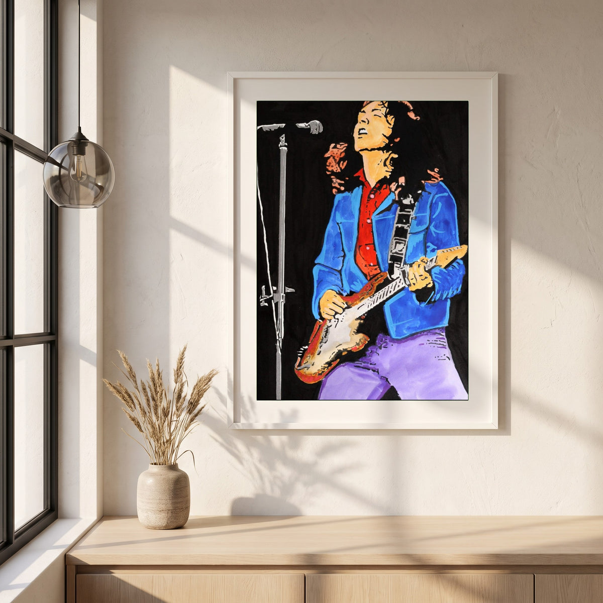 Rory Gallagher framed print in a white frame on a plaster wall above an oak worktop in a bright Scandinavian kitchen