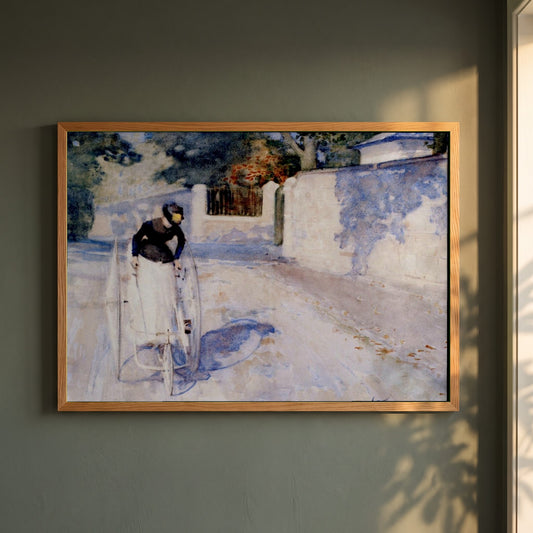 Women on a Safety Tricycle framed print in a natural oak frame on a dark green wall beside a window, dappled plant shadow