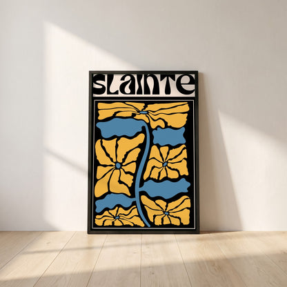 Sláinte framed print in a black frame leaning against a white plaster wall on oak floorboards in morning light