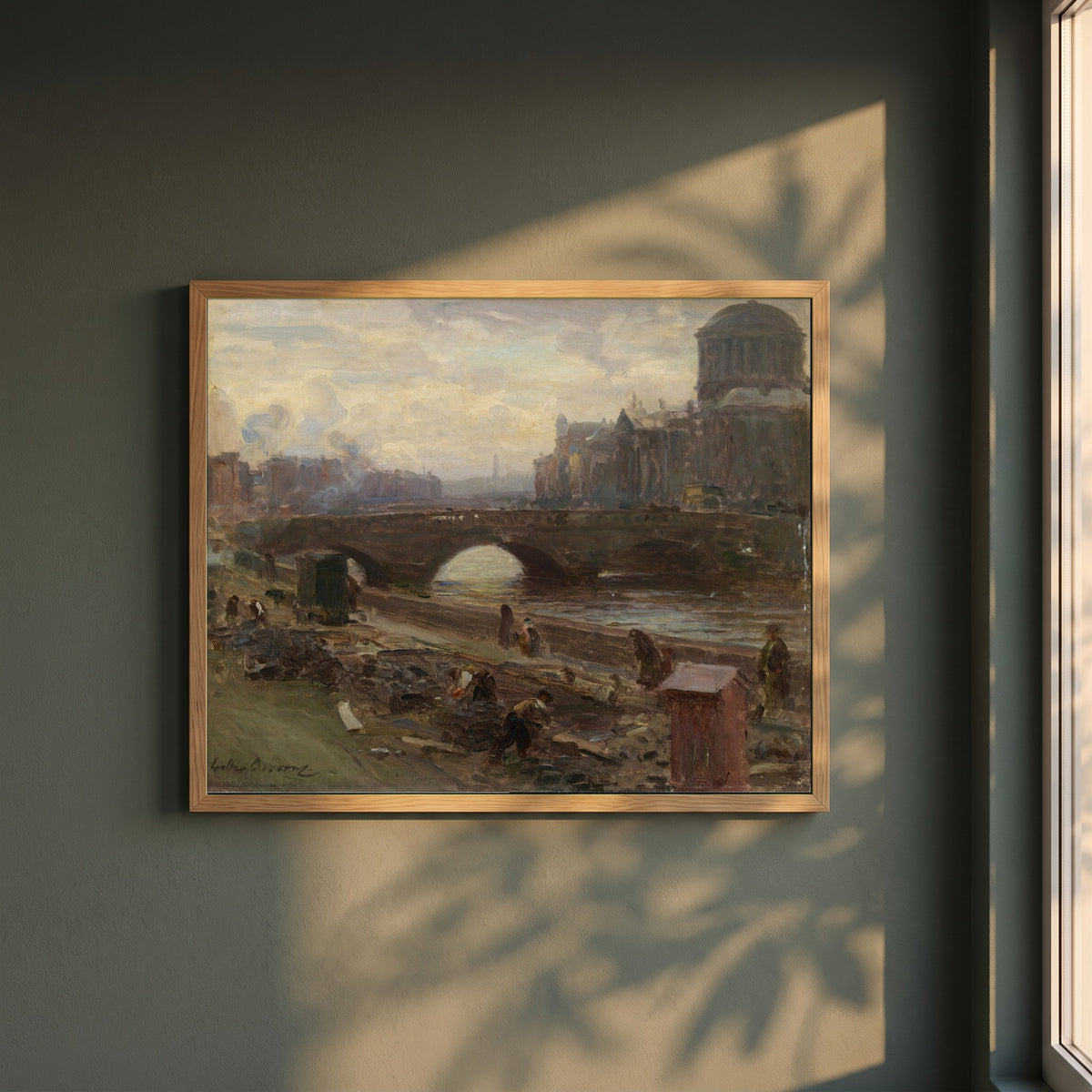 The Four Courts, Dublin framed print in a natural oak frame on a dark green wall beside a window, dappled plant shadow