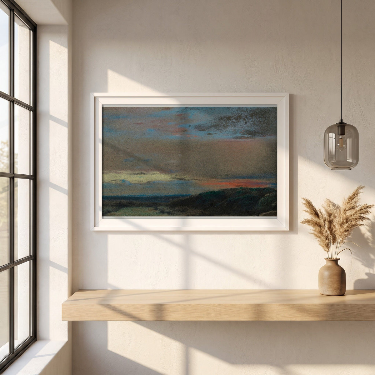 The Moor at Sunrise framed print in a white frame on a plaster wall above an oak worktop in a bright Scandinavian kitchen