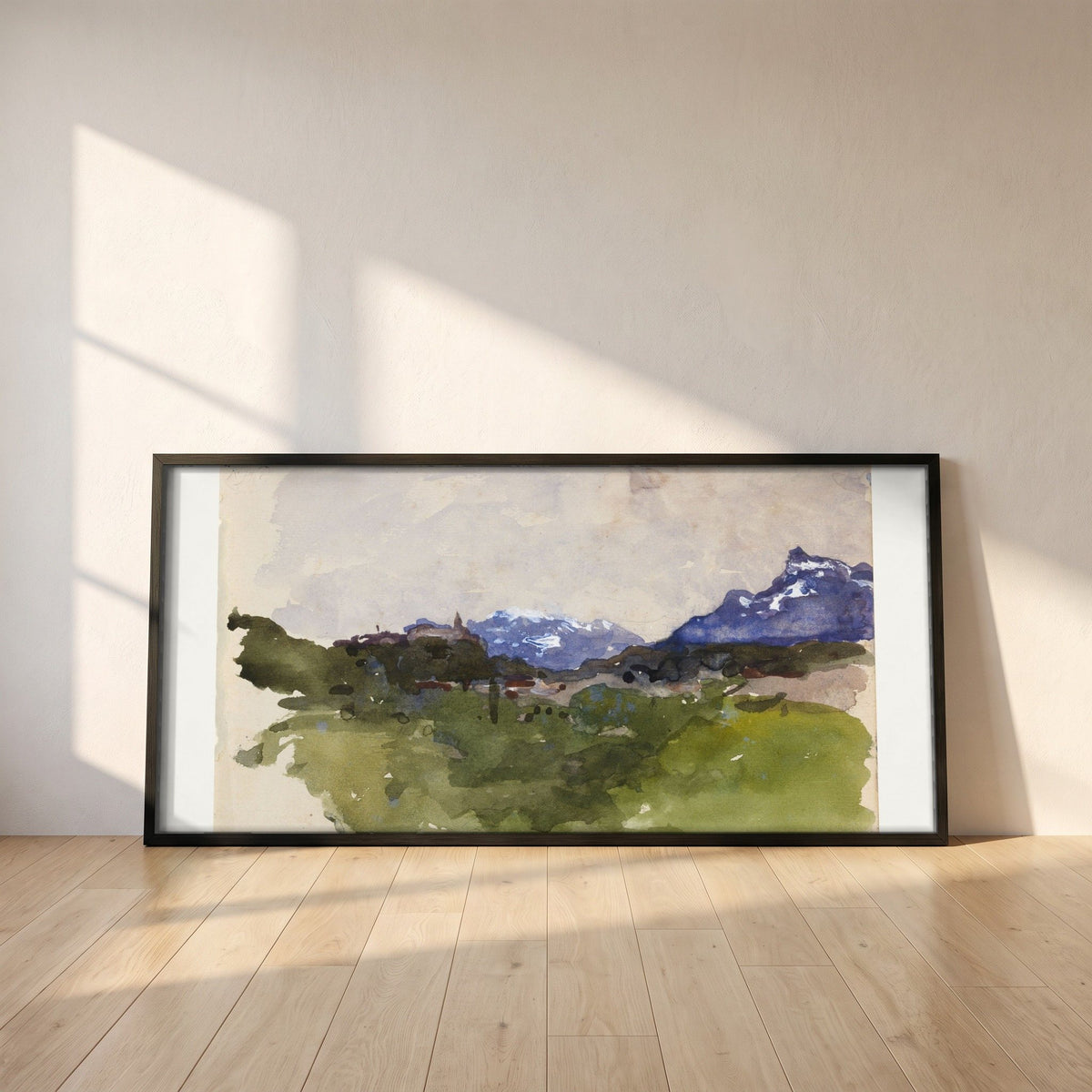 The Pyrenees Mountains framed print in a black frame leaning against a white plaster wall on oak floorboards in morning light