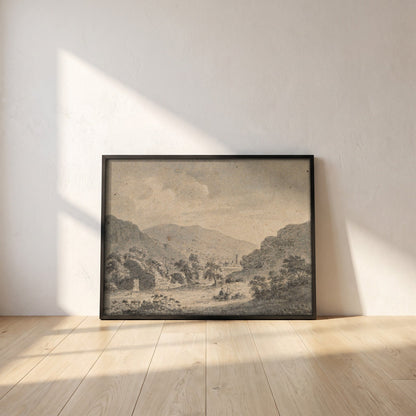 The Round Tower, Glendalough, from Temple-na-Skellig framed print in a black frame leaning against a white plaster wall on oak floorboards in morning light