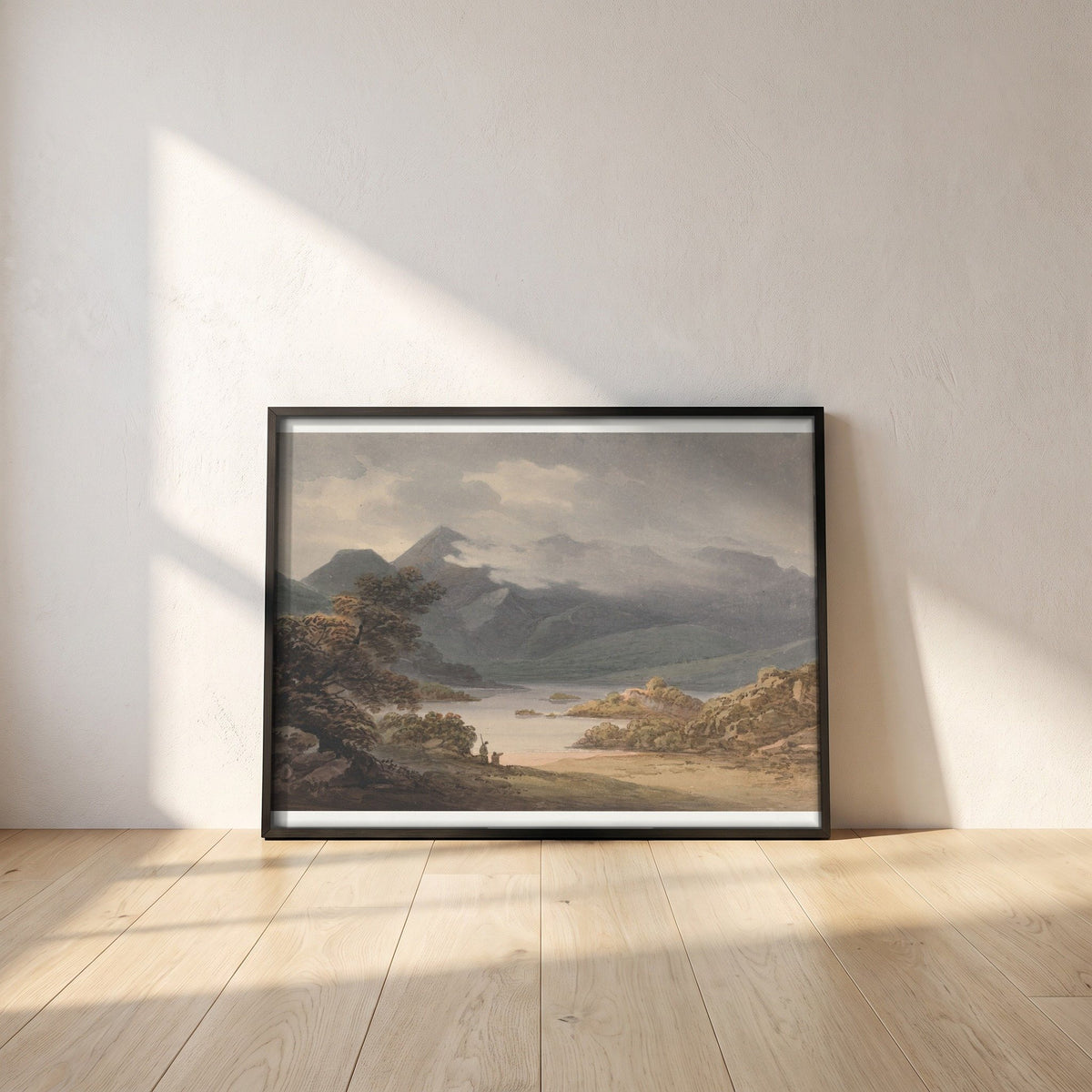 View on the Upper Lake, Killarney framed print in a black frame leaning against a white plaster wall on oak floorboards in morning light