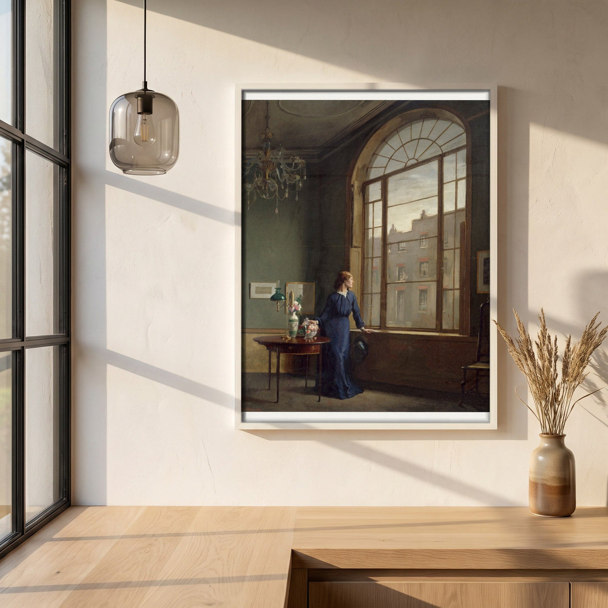 Window in London Street framed print in a white frame on a plaster wall above an oak worktop in a bright Scandinavian kitchen